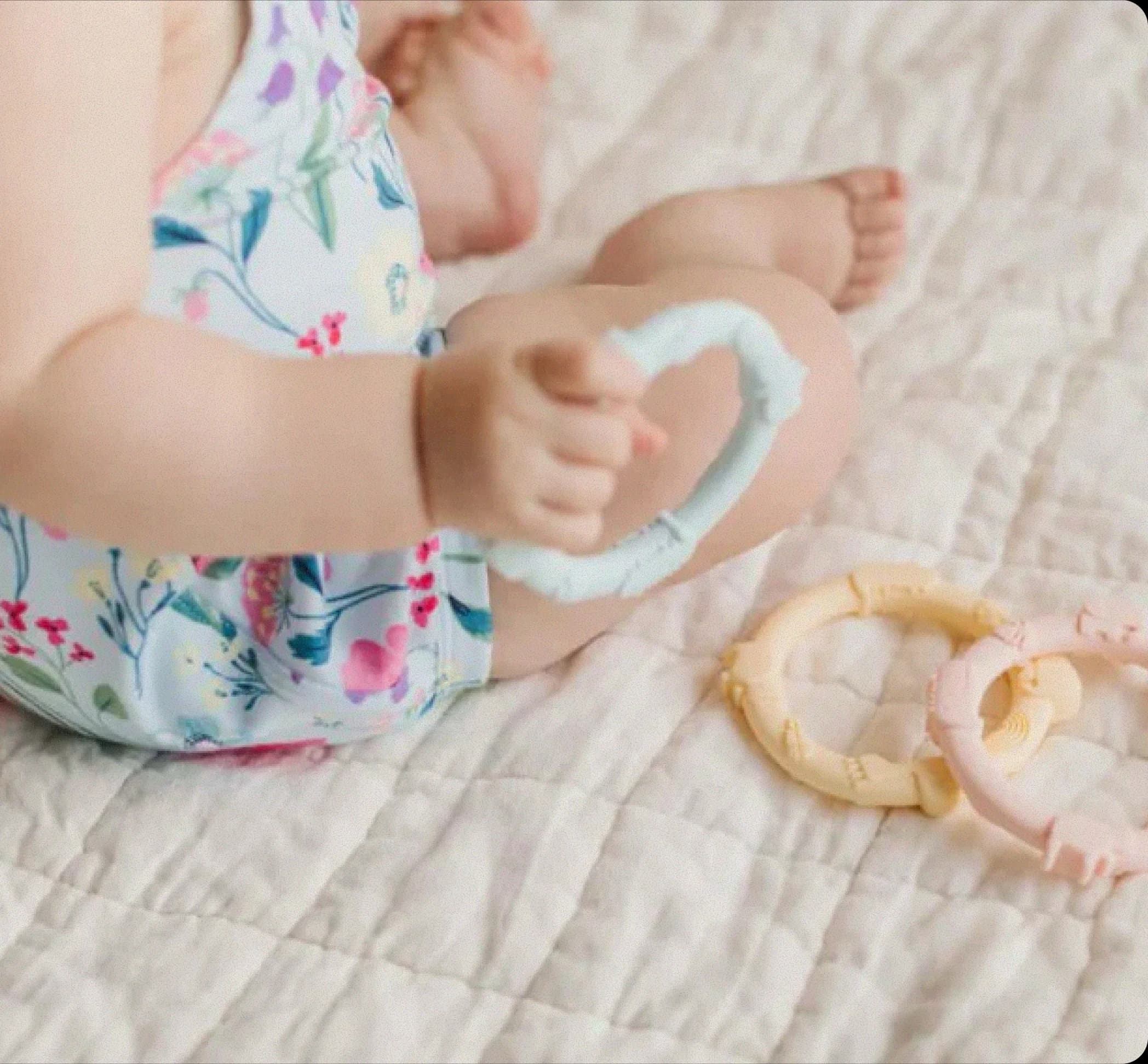 Baby playing with Loulou Lollipop teething rings