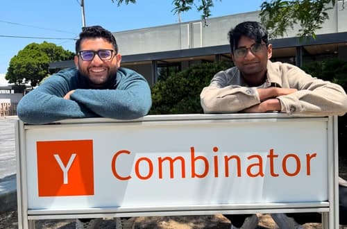 Shor co-founders Daivik Goel and Avi Konduru leaning on the Y Combinator sign in Mountain View